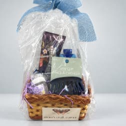 Gift basket with hair accessories and small personal care items in plastic wrap