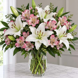 White lilies and pink alstroemeria in a clear glass vase