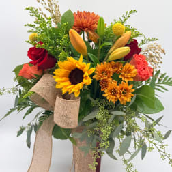 Bouquet of mixed flowers with a burlap ribbon wrap