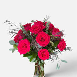 Bouquet of bright pink roses in a clear glass vase