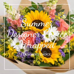 Wrapped bouquet with sunflowers, roses, daisies, and purple filler flowers