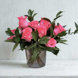 Pink roses arranged in a clear glass vase