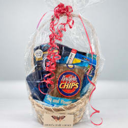 Gift basket with snacks and car air fresheners wrapped in clear plastic with red ribbon