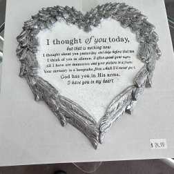 Silver heart-shaped memorial plaque with a printed sympathy verse