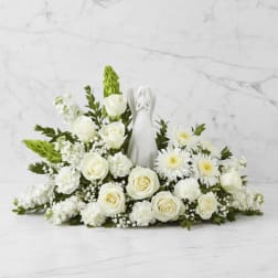 White rose and daisy arrangement with an angel figurine