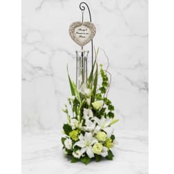 White floral sympathy arrangement with a heart memorial ornament