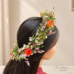 Woman wearing a floral crown with orange and white blossoms