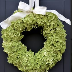 Green hydrangea wreath with a white ribbon bow
