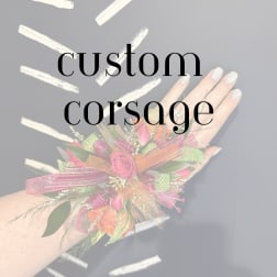 Custom corsage with pink roses and ribbon on a wrist
