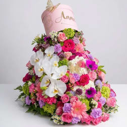 Large pink floral arrangement with white orchids and roses in a pink hatbox