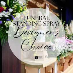 Funeral standing spray with white, purple, and yellow flowers