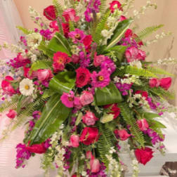 Large pink and white floral spray with ferns and broad leaves