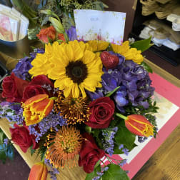 Mixed bouquet with sunflowers, roses, hydrangeas, and tulips