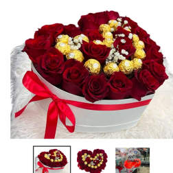 Heart-shaped box of red roses with gold-wrapped chocolates and baby's breath