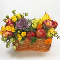 Fruit basket with roses and apples in a woven basket