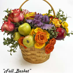 Basket arrangement of roses and apples with a wooden handle