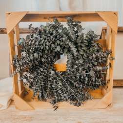 Wooden crate filled with dried eucalyptus branches