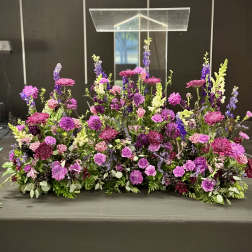 Large purple and pink floral arrangement on a table