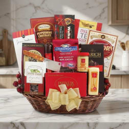 Basket of assorted chocolates, cookies, and snacks with a gold bow