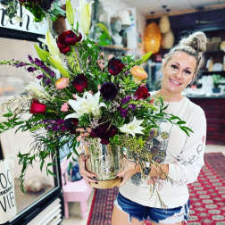 Large mixed bouquet in a glass vase with lilies and roses
