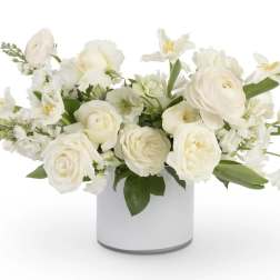 White floral arrangement in a white cylindrical vase