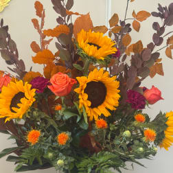 Bouquet with sunflowers, coral roses, and purple carnations