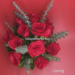 Bouquet of red roses with eucalyptus on a pink background
