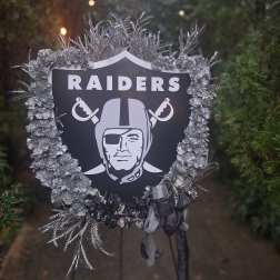 Raiders memorial wreath with silver flowers and ribbon