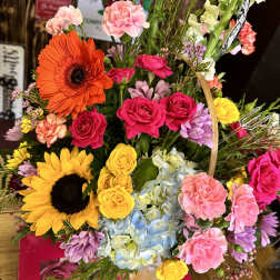 Colorful mixed bouquet with sunflowers, roses, hydrangeas, and carnations