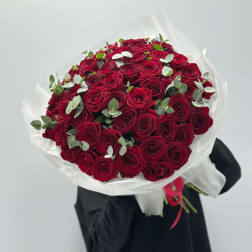 Large bouquet of red roses wrapped in white paper