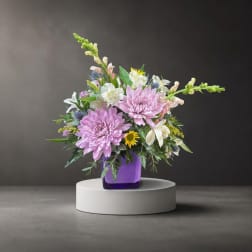 Lavender and white mixed bouquet in a purple vase
