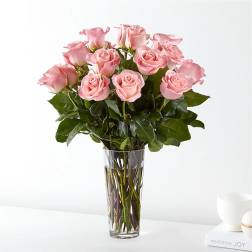 Pink roses arranged in a clear glass vase