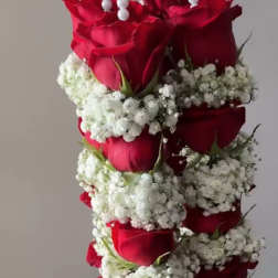 Hanging arrangement of red roses and white baby's breath