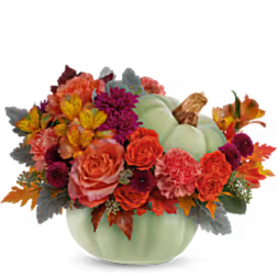 Pumpkin-shaped vase with orange and purple flowers