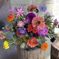 Colorful mixed bouquet in a rustic wooden container