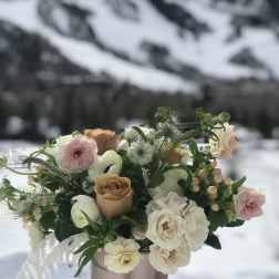 Pastel bouquet of roses and white blooms in a pink vase