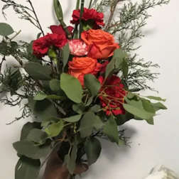 Bouquet of orange and red roses with greenery