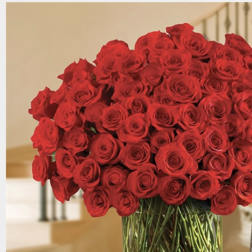 Large bouquet of red roses in a clear glass vase