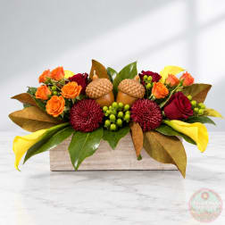 Autumn floral arrangement with roses, calla lilies, and chrysanthemums in a wooden box