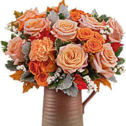 Peach and orange rose bouquet in a brown vase