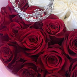Bouquet of red and white roses with a jeweled crown