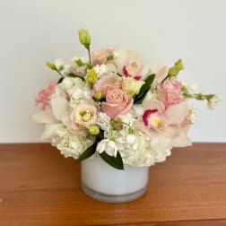 Pink and white floral arrangement in a white vase