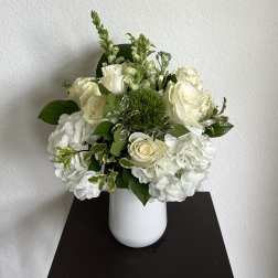 White roses and hydrangeas in a white vase