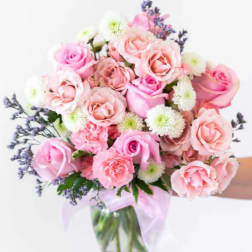 Pink and white rose bouquet in a clear glass vase