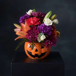 Colorful bouquet in a jack-o'-lantern vase