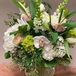 Bouquet of white and pale pink flowers in a glass vase