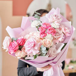 Pink and white rose bouquet wrapped in pastel paper