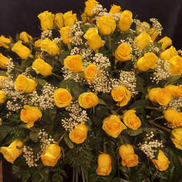 Large bouquet of yellow roses with white filler flowers