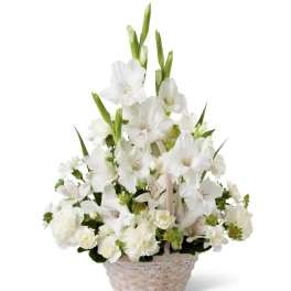 White gladiolus and carnation basket arrangement with tall spikes and round blooms
