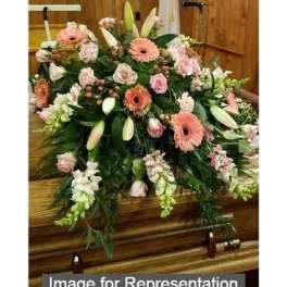 Large pink and white floral casket spray with lilies and roses